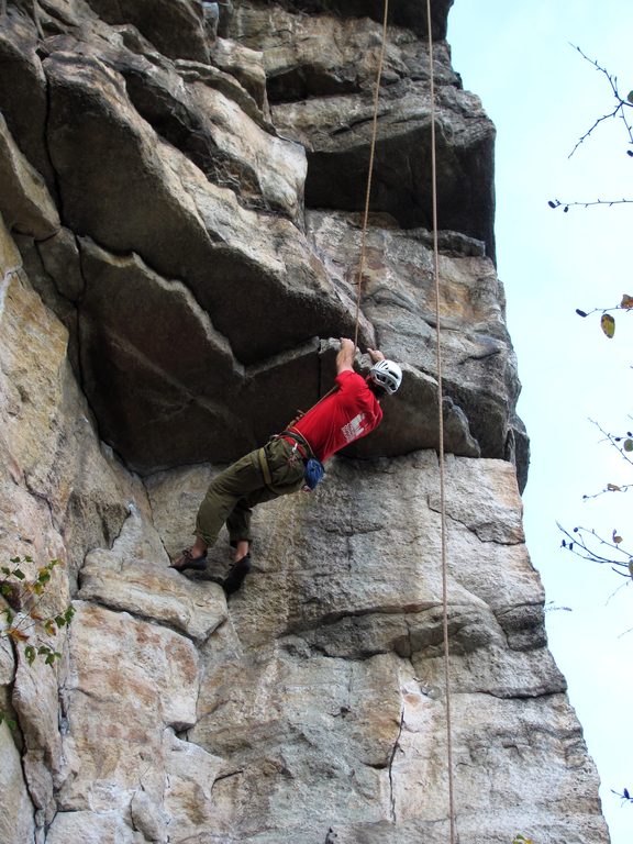 Pulling through the lower roof. (Category:  Rock Climbing)