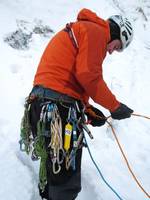 Guy getting ready to hike the first pitch on Eye Of The Needle. (Category:  Ice Climbing)