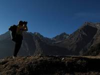 Dave taking photos.  The Laurebina Pass is visible in the center of the photo. (Category:  Travel)