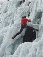 Me stemming past a large window in the ice. (Category:  Ice Climbing)