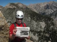 Mike reading his hometown newspaper at the top of pitch 11. (Category:  Rock Climbing)