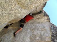 Me on Potluck.  Left leg crammed completely in the crack. (Category:  Rock Climbing)