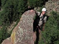 Tom at the top of Rewritten's very exposed final arete. (Category:  Rock Climbing)