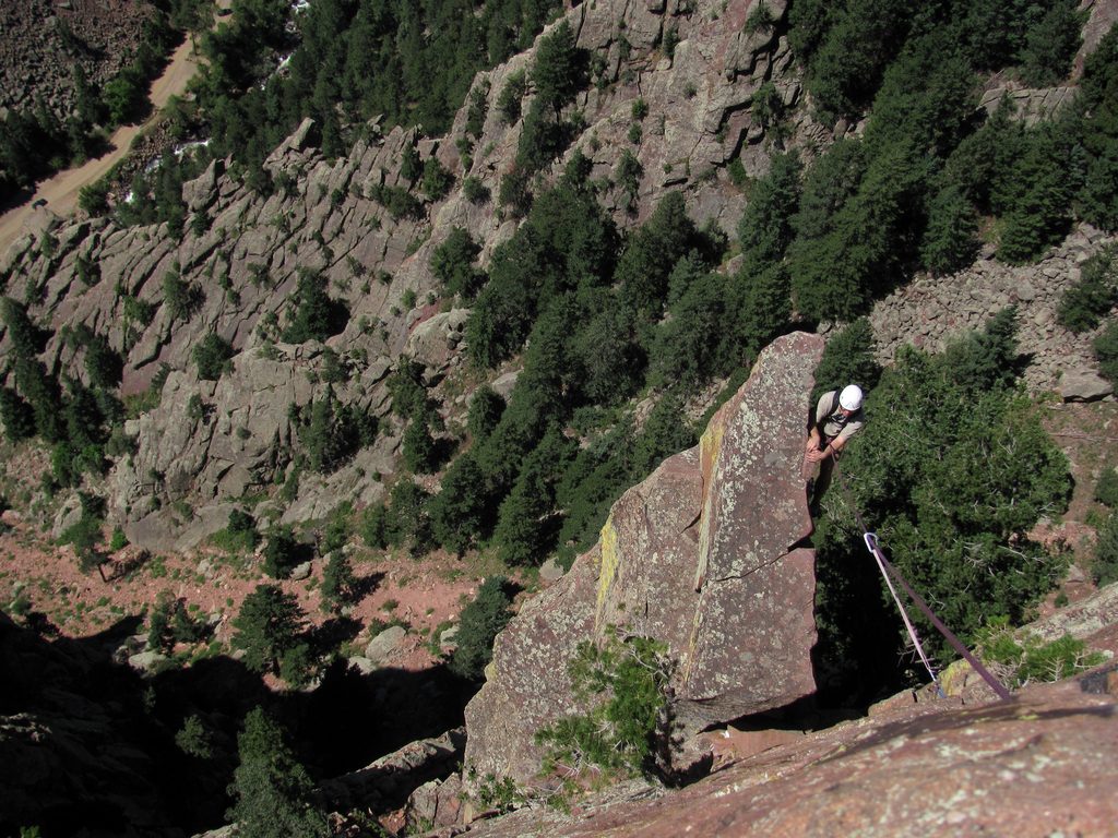 Tom at the top of Rewritten's very exposed final arete. (Category:  Rock Climbing)