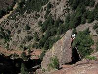 Tom at the top of Rewritten's very exposed final arete. (Category:  Rock Climbing)