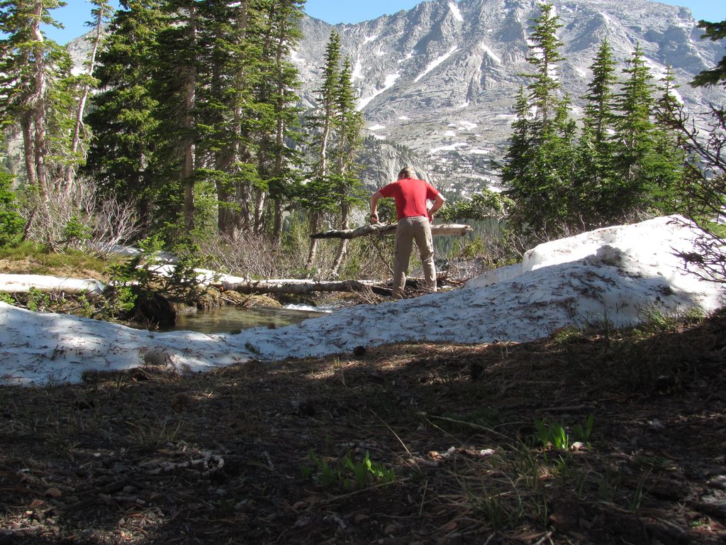 Mike building a bridge across the creek. (Category:  Rock Climbing)