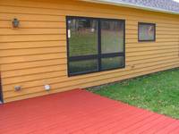 Back of the house and newly stained deck. (Category:  Residence)