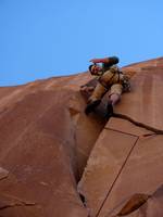 Guy pointing to the giant hold he failed to notice while attempting to onsight Crack Attack. (Category:  Rock Climbing)
