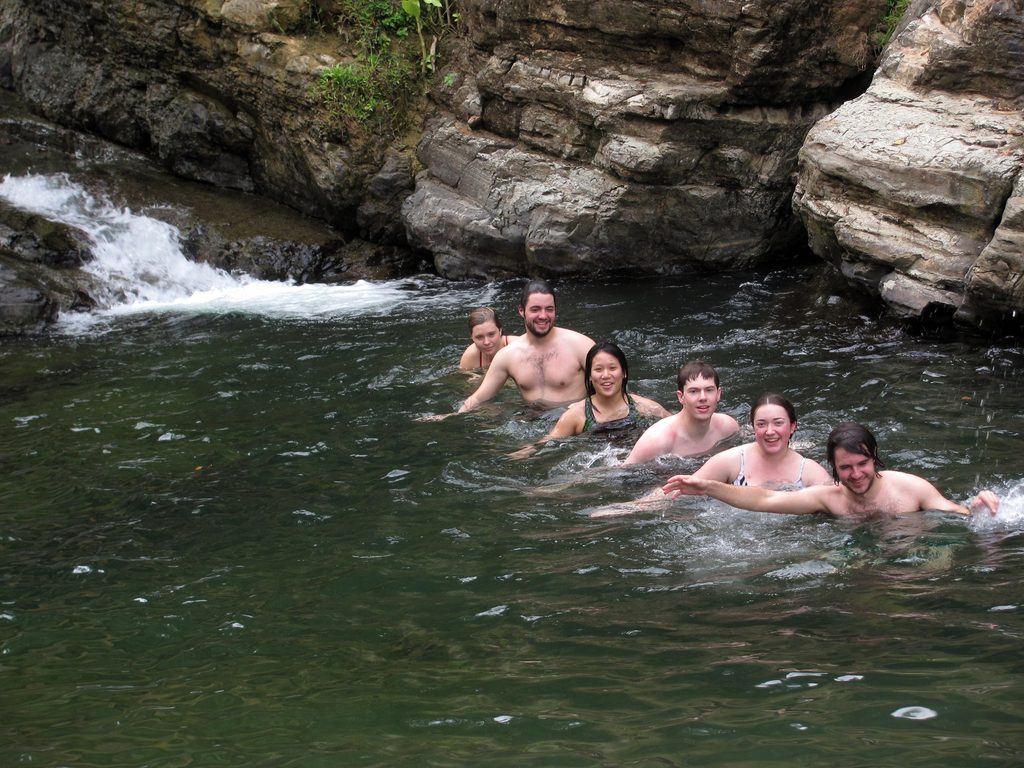 Cat, Colin, Becky, Andrew, Tara and Eric all sitting on a submerged log. (Category:  Travel)