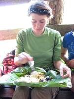 Laetitia eating rice and beans in a banana leaf. (Category:  Travel)