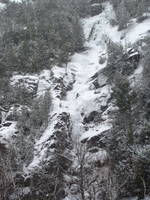 Tammy leading the first pitch of Chouinard's Gully in the middle of a winter storm. (Category:  Ice Climbing)