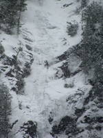 Tammy leading the first pitch of Chouinard's Gully in the middle of a winter storm. (Category:  Ice Climbing)