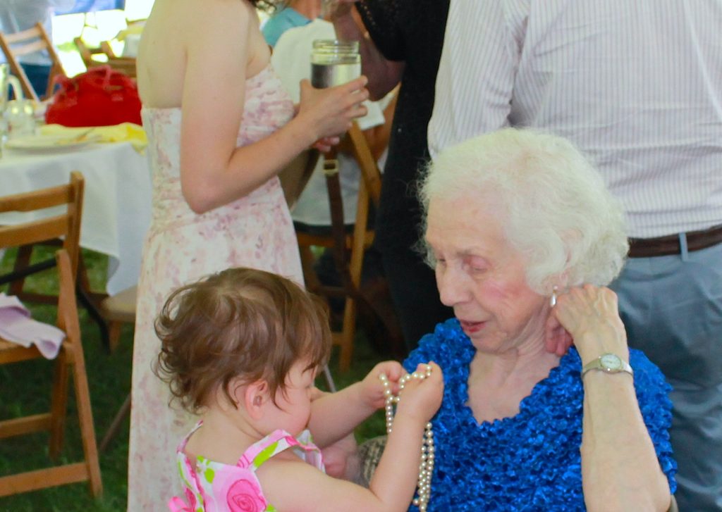 Certain great-grandchildren may or may not be interested in testing necklace durability. (Category:  Party)