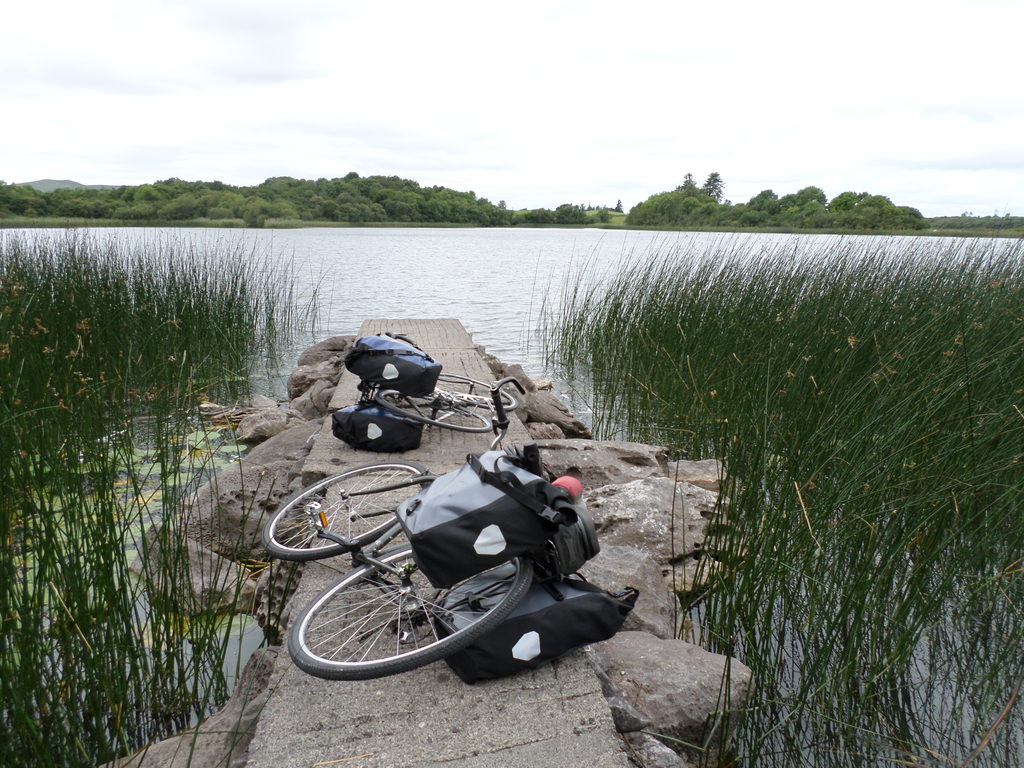 We stopped for lunch at Ross Lake. We dragged our bikes along a trail in the woods, and when it opened out along the edge of the lake there were these little piers every few yards, which created private spaces for all the different people there (Category:  Travel)