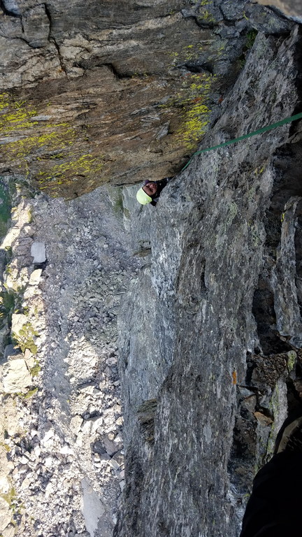 Camille puzzling out the crux move on the seventh pitch (Category:  Climbing)